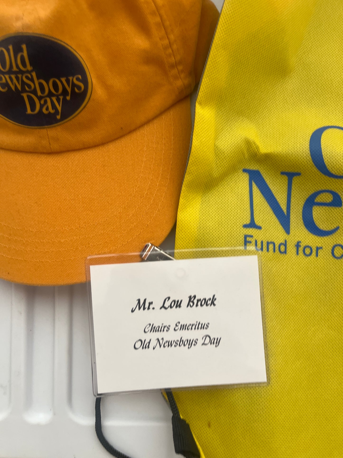 Lou Brock's name tag And hat from old newsboys day including bag